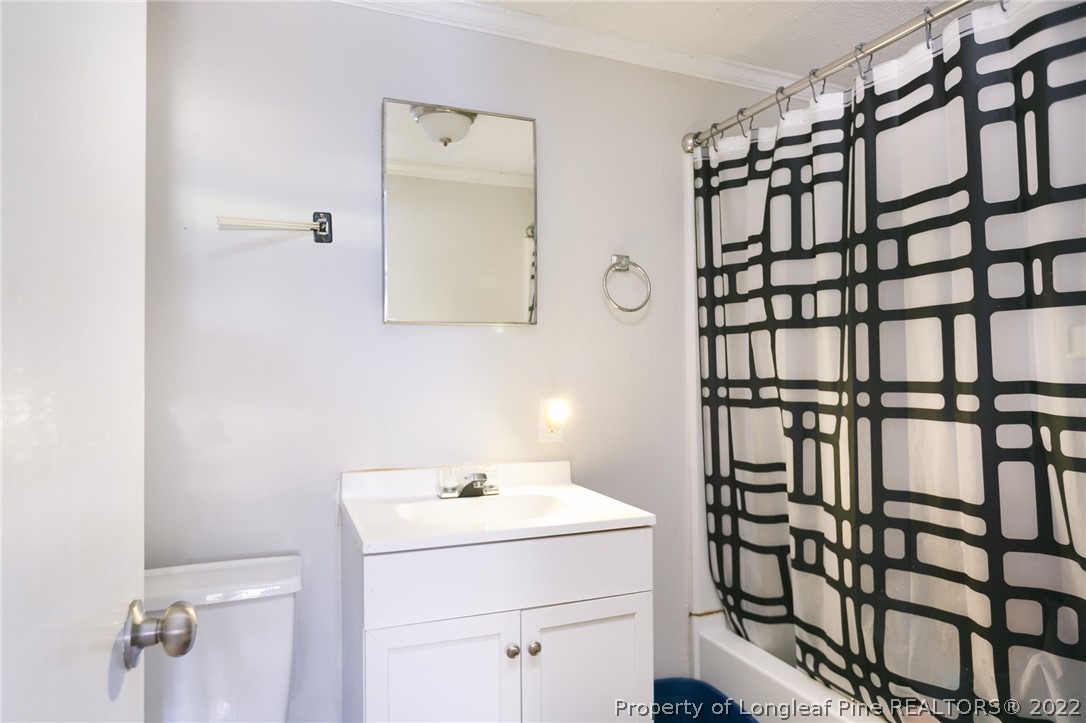 117 Ruth Street Fayetteville, NC 28305 - Photo 14 of 27 a bathroom with a sink and a mirror