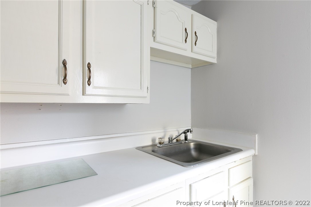 117 Ruth Street Fayetteville, NC 28305 - Photo 15 of 27 a kitchen with stainless steel appliances a sink and cabinets