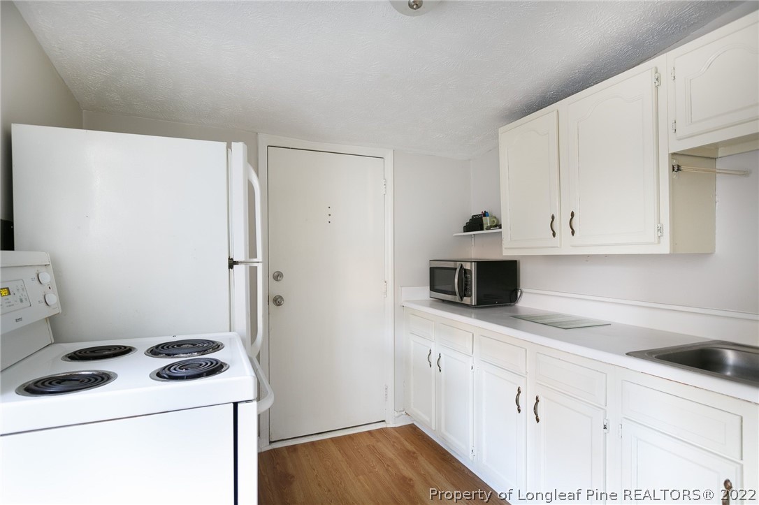 117 Ruth Street Fayetteville, NC 28305 - Photo 16 of 27 a kitchen with a cabinets and white appliances