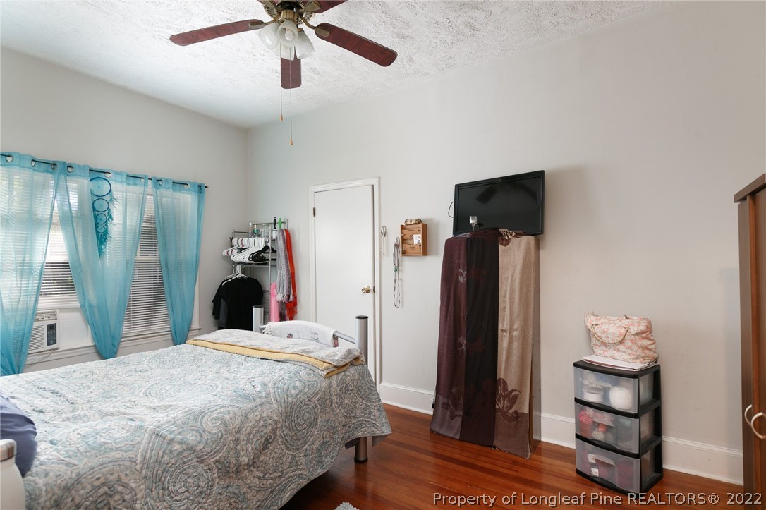 117 Ruth Street Fayetteville, NC 28305 - Photo 7 of 27 a bed room with a bed and a chandelier