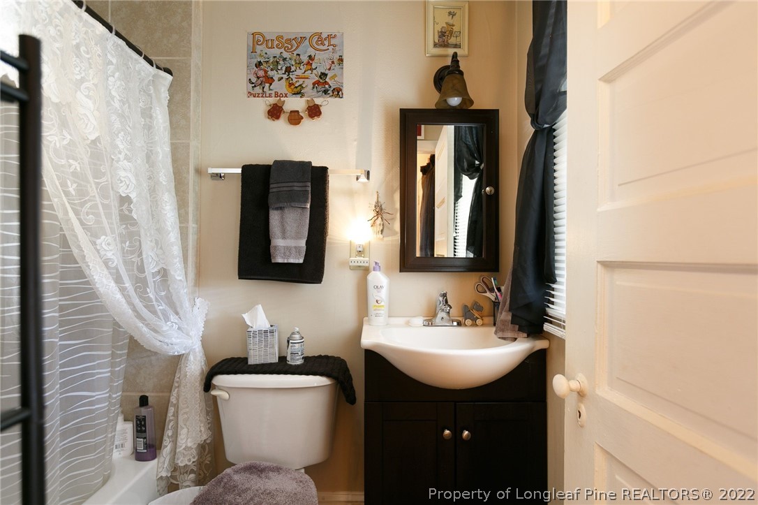 117 Ruth Street Fayetteville, NC 28305 - Photo 8 of 27 a bathroom with a toilet sink and mirror