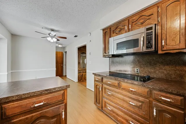 a kitchen with stainless steel appliances granite countertop a stove and a microwave