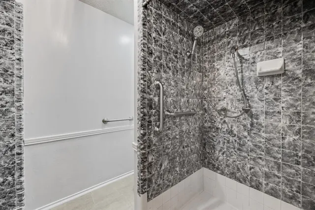 a bathroom with a sink and shower