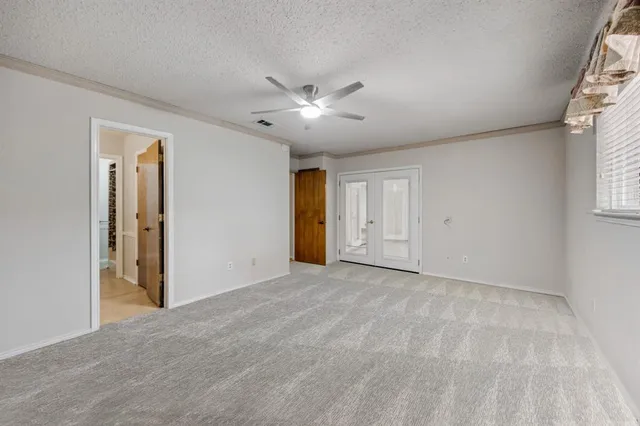 a view of an empty room with a window and balcony