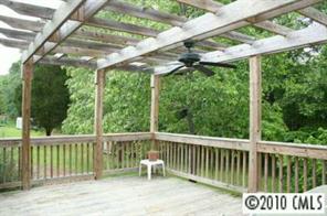 1239 Micol Road Newton, NC 28658 - Photo 2 of 8 a view of a deck with a floor to ceiling window and a yard