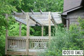 1239 Micol Road Newton, NC 28658 - Photo 7 of 8 a view of a wooden deck and a yard with wooden fence