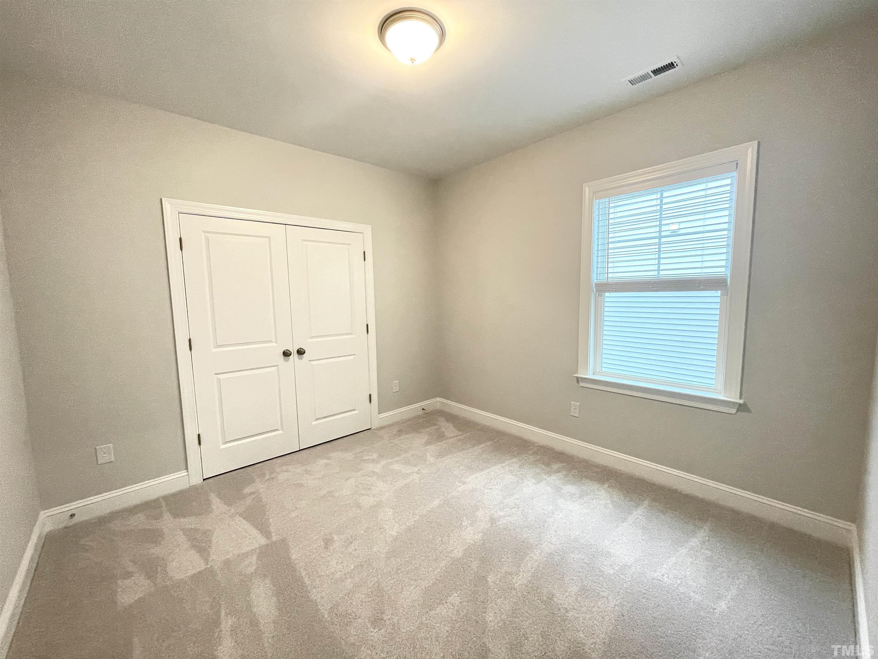 207 Edge Of Auburn Boulevard Raleigh, NC 27610 - Photo 13 of 22 an empty room with windows