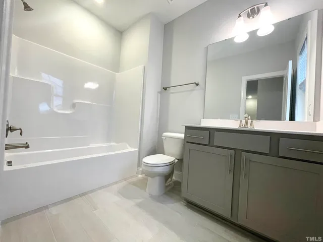 a bathroom with a toilet a sink and a bathtub