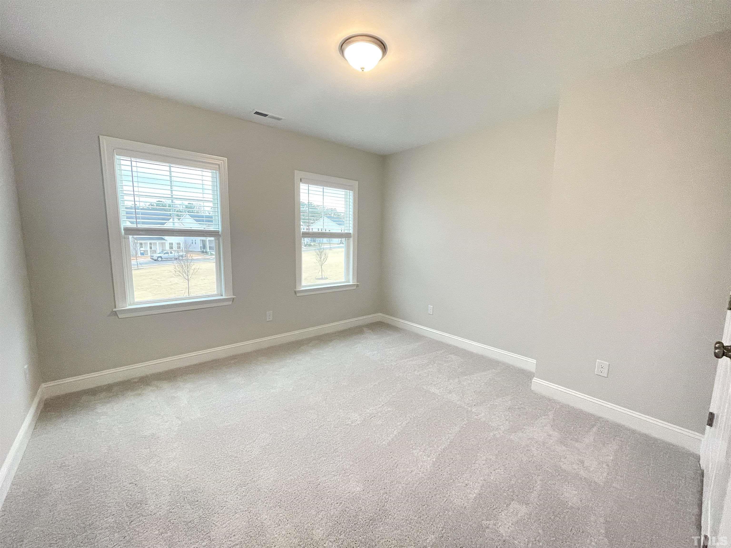 207 Edge Of Auburn Boulevard Raleigh, NC 27610 - Photo 17 of 22 an empty room with windows