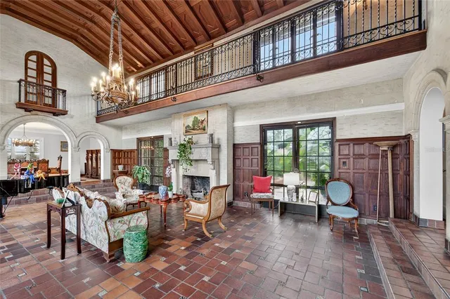 a view of a dining room with furniture and chandelier