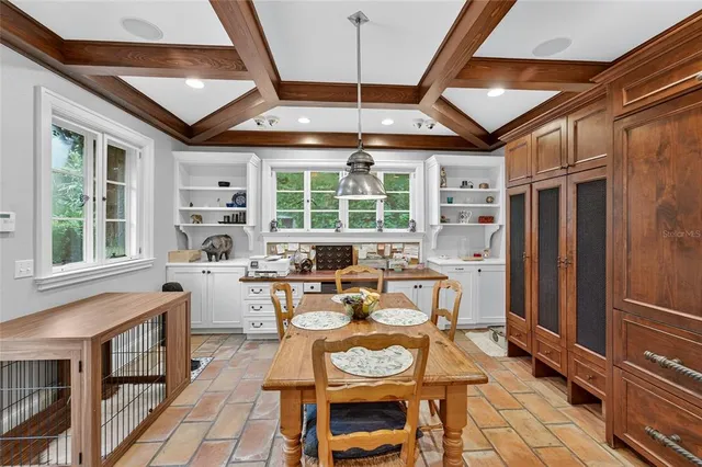 a spacious bedroom with a bed a couch and large window