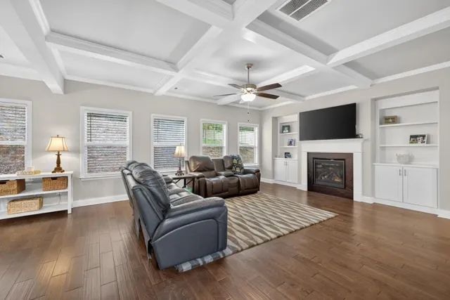 a kitchen with kitchen island a counter top space stainless steel appliances and windows