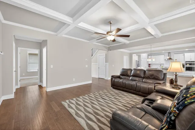 a kitchen with stainless steel appliances granite countertop white cabinets and a stove