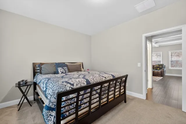 a spacious bedroom with a bed a couch and large windows