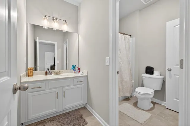 a spacious bedroom with a bed a window and closet