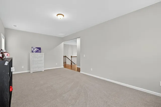 a view of walk in closet with clothes