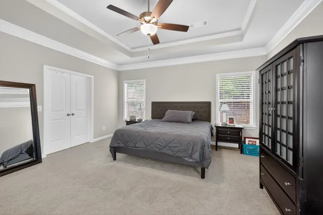 an aerial view of a residential houses with an outdoor space and seating