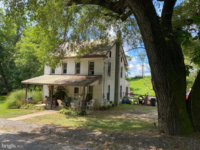a view of a house with backyard porch and sitting area