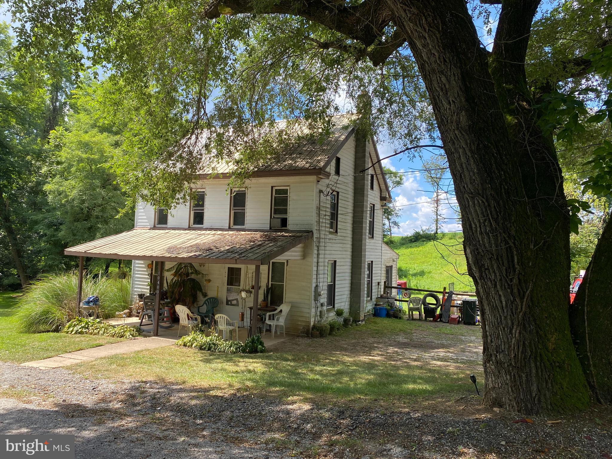 a view of a house with backyard porch and sitting area