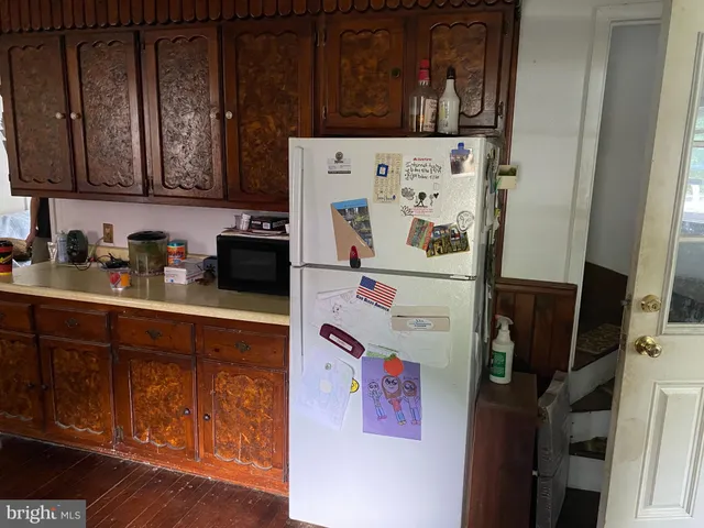 a white refrigerator freezer sitting inside of a kitchen