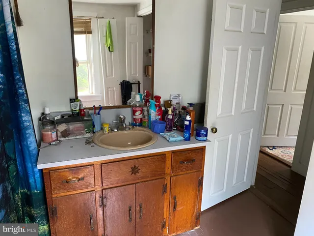 a view of a sink and a refrigerator