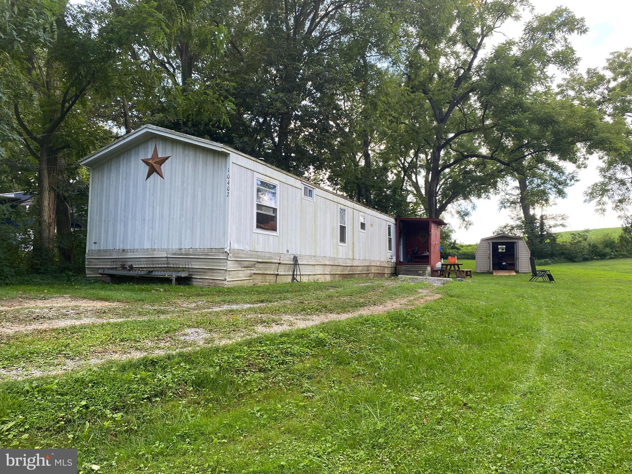 10400 Enfield Road Felton, PA 17322 - Photo 18 of 36 a backyard of a house with wooden fence and large trees