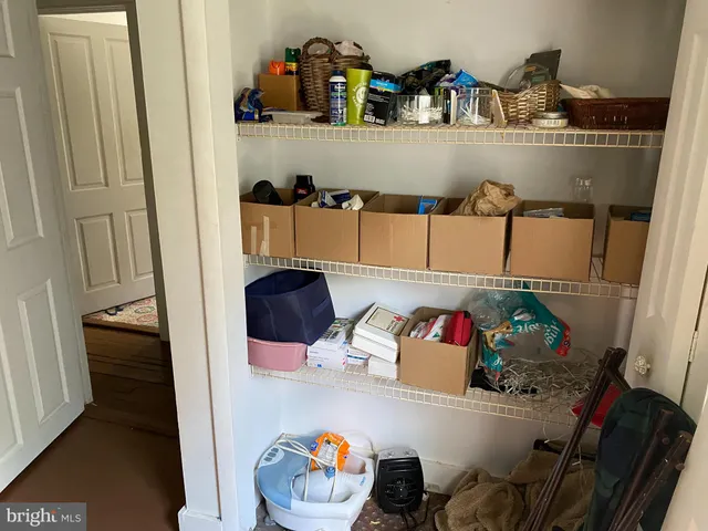 a shelf with dining table and chairs