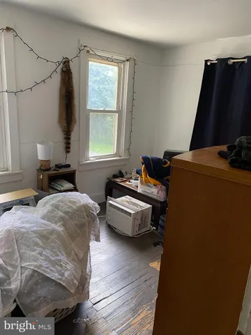 a bedroom with bed and window