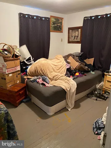 a bedroom with a bed and dresser