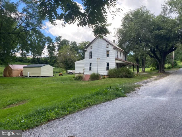 a front view of house with yard and trees