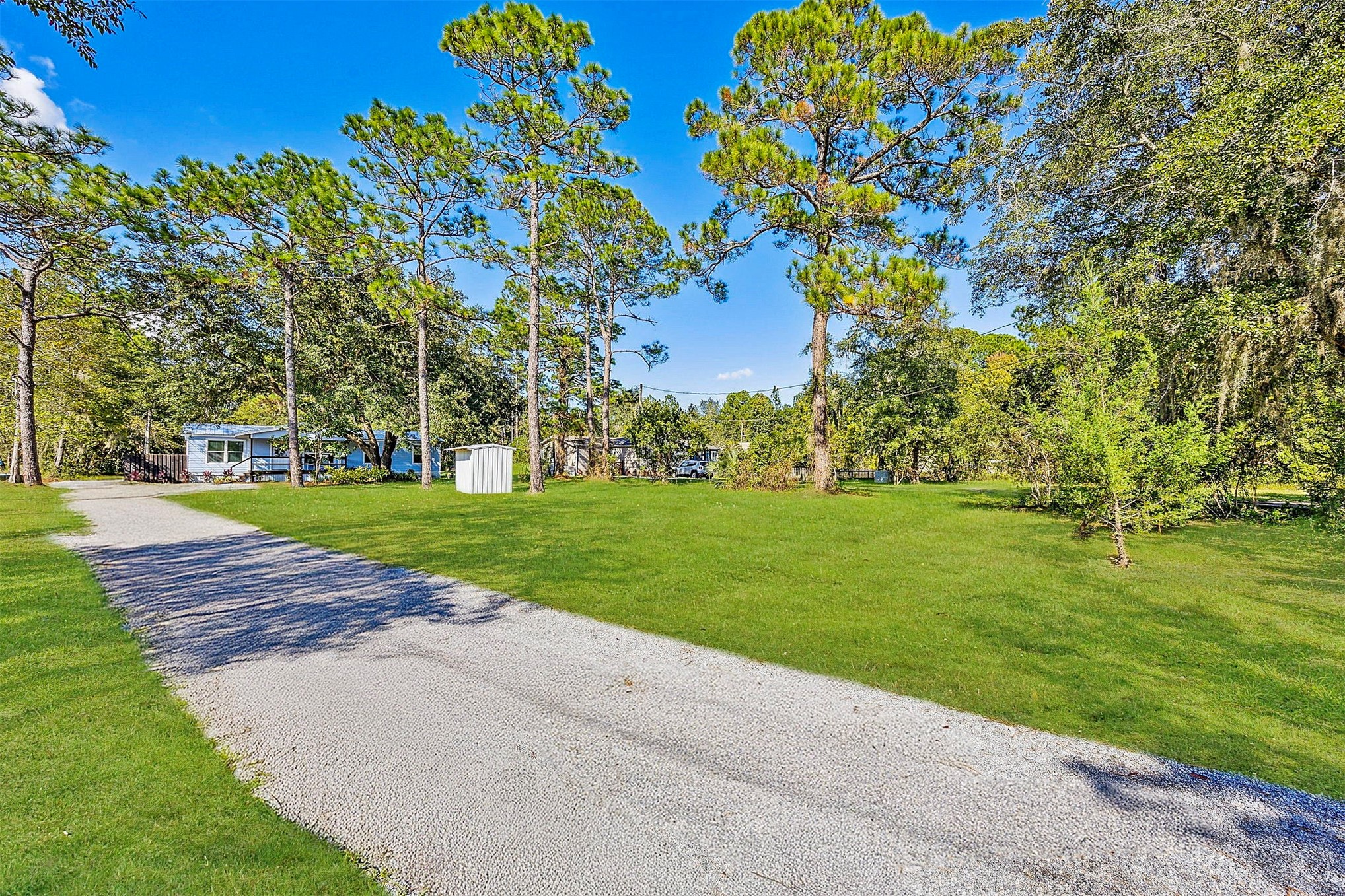 95539 Tyson Road Fernandina Beach, FL 32034 - Photo 4 of 38 ...a new gravel driveway and landscaped yard