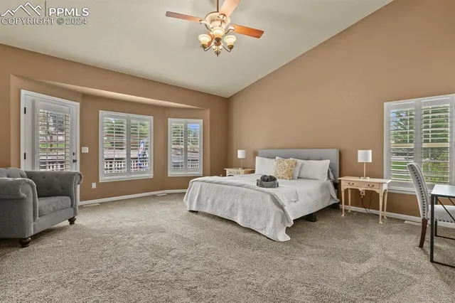 a spacious bedroom with a bed and a couch