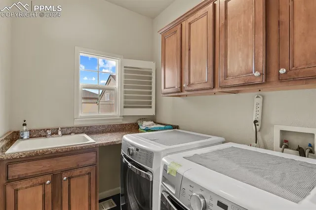 a utility room with a sink washer and dryer