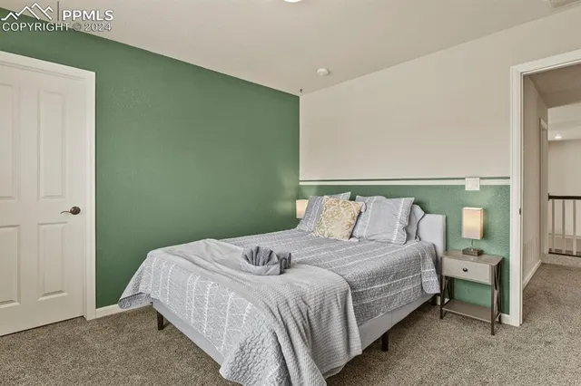 a bedroom with a bed and a night stand