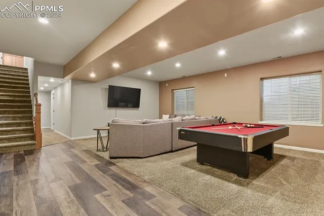 a living room with a flat screen tv and a table