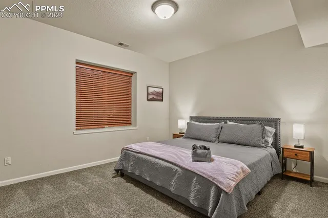 a bedroom with a bed and window