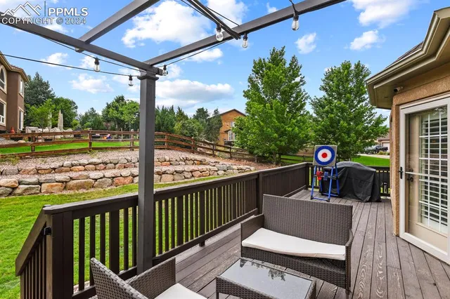 a view of a porch with furniture and a yard