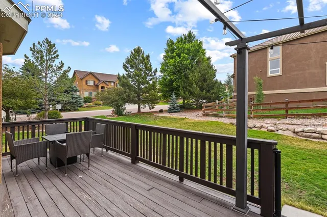 a view of a balcony with wooden floor and outdoor seating