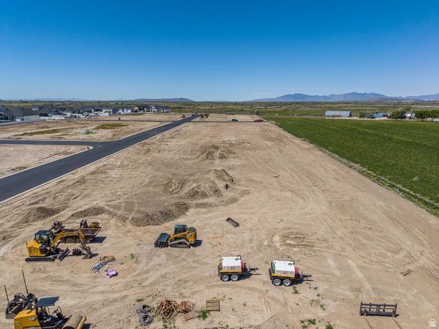 3187 South 5250 West, Unit 212 Hooper, UT 84315 - Photo 1 of 10 Expansive undeveloped land featuring graded terrain, newly paved roadways, and mountain backdrops
