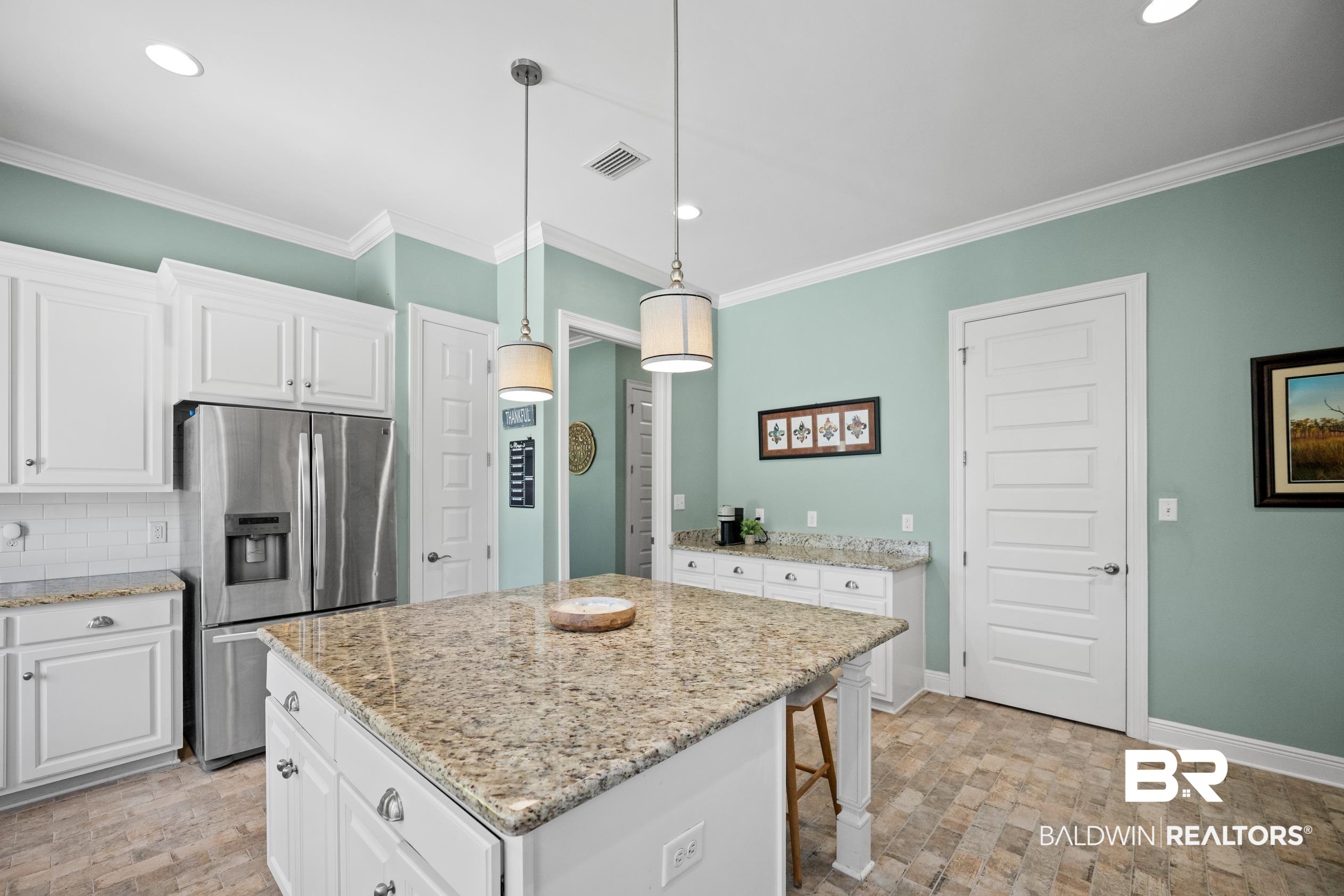 9060 Bromley Road Bay Minette, AL 36507 - Photo 20 of 63 Kitchen featuring stainless steel fridge with ice dispenser, ornamental molding, white cabinets, recessed lighting, and a center island