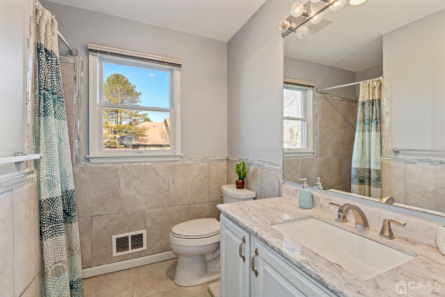 16 Allison Court Edison, NJ 08820 - Photo 14 of 33 a bathroom with a granite countertop sink toilet and painting on the wall