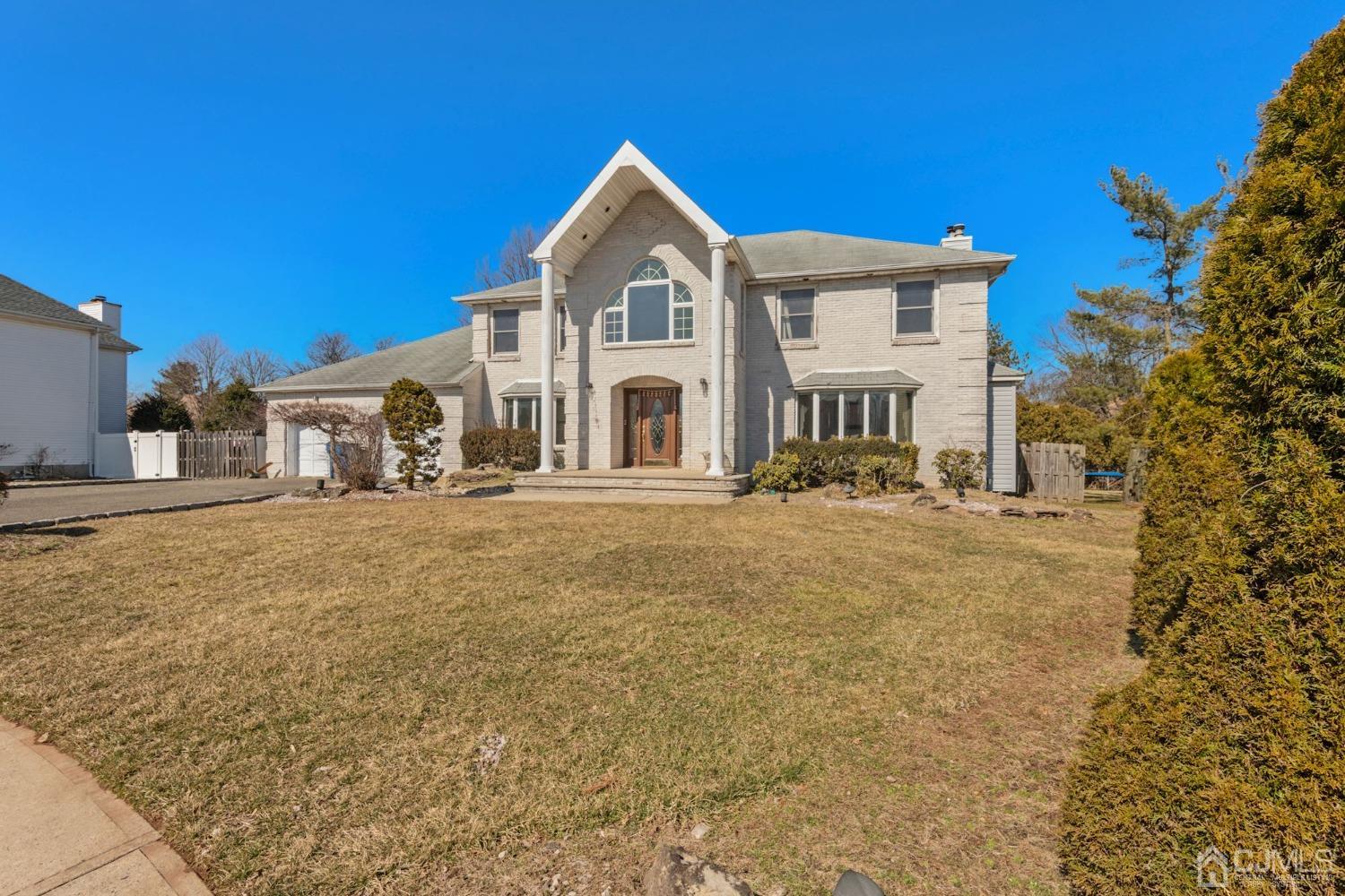 16 Allison Court Edison, NJ 08820 - Photo 2 of 33 a front view of a house with large trees