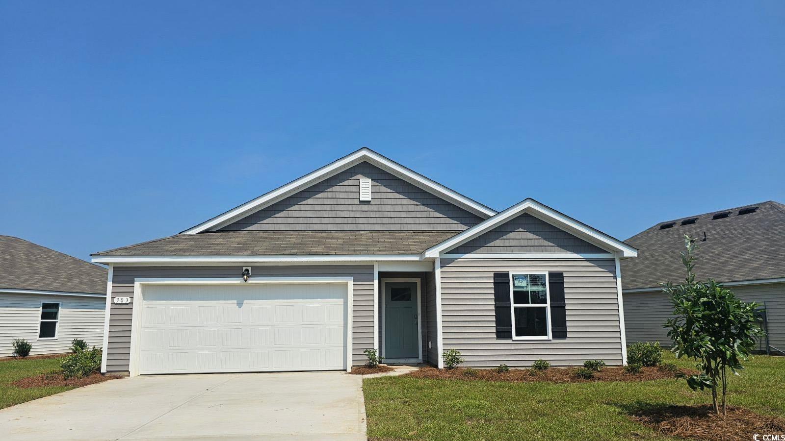 139 Cottage Red Court Conway, SC 29527 - Photo 1 of 21 View of front facade with concrete driveway, a front lawn, a shingled roof, and an attached garage