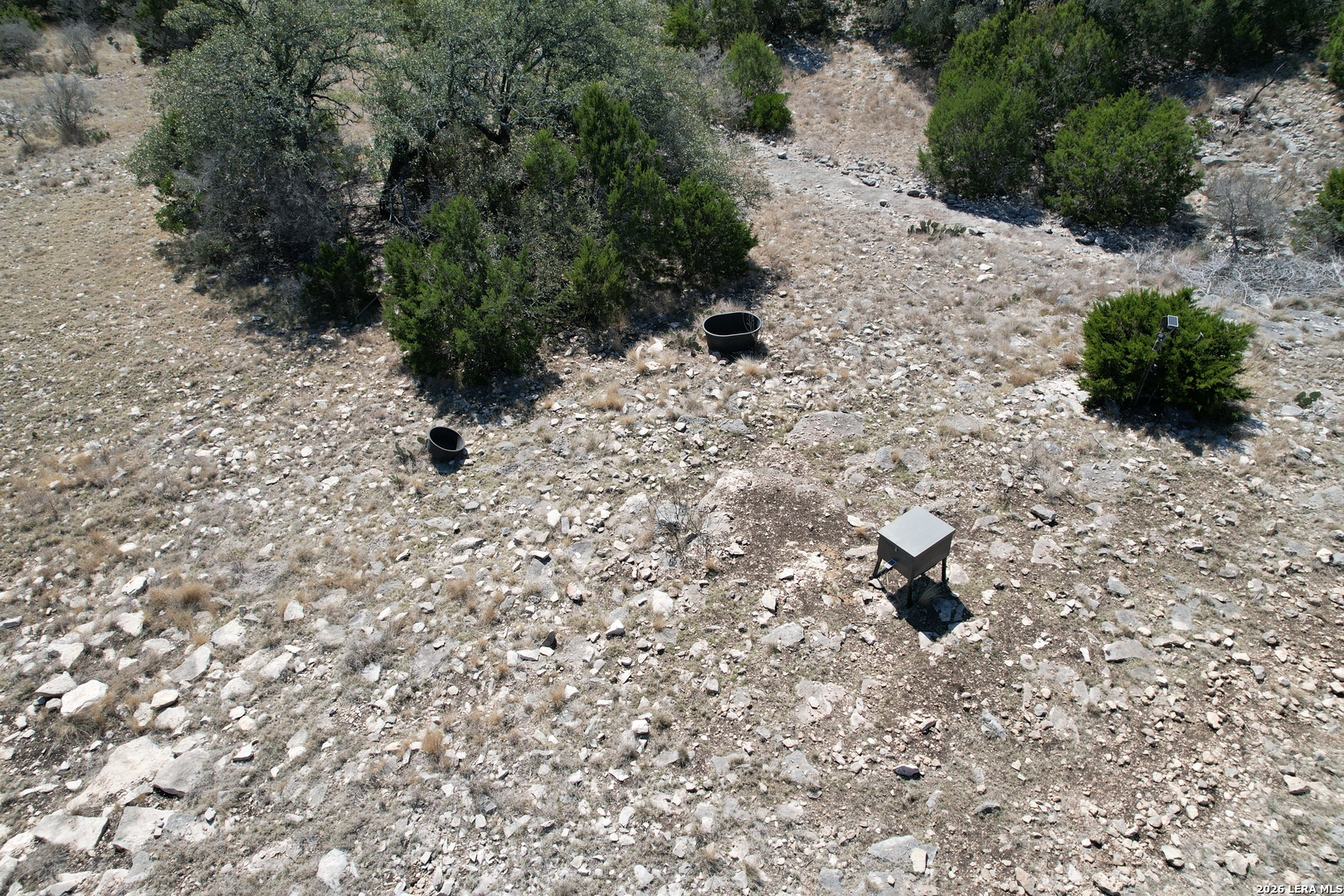 1213 SD 42200 Rocksprings, TX 78880 - Photo 6 of 33 a white house with trees in the background