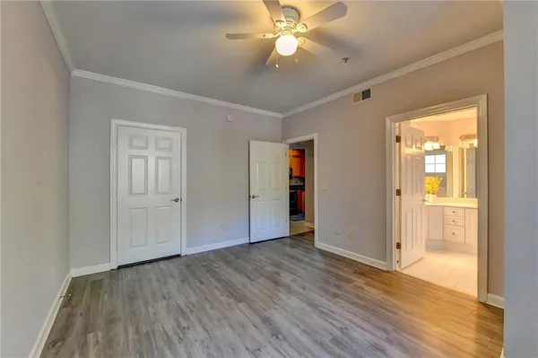 a view of an empty room with wooden floor