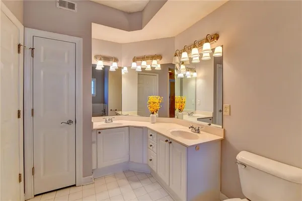 a bathroom with a double vanity sink and a mirror