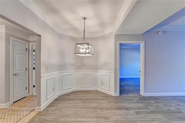 a view of empty room with wooden floor and window