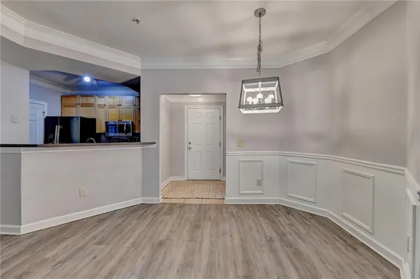 a view of a room with wooden floor and white cabinet