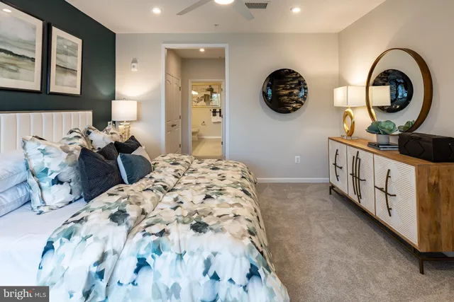 a bedroom with bed and a large mirror