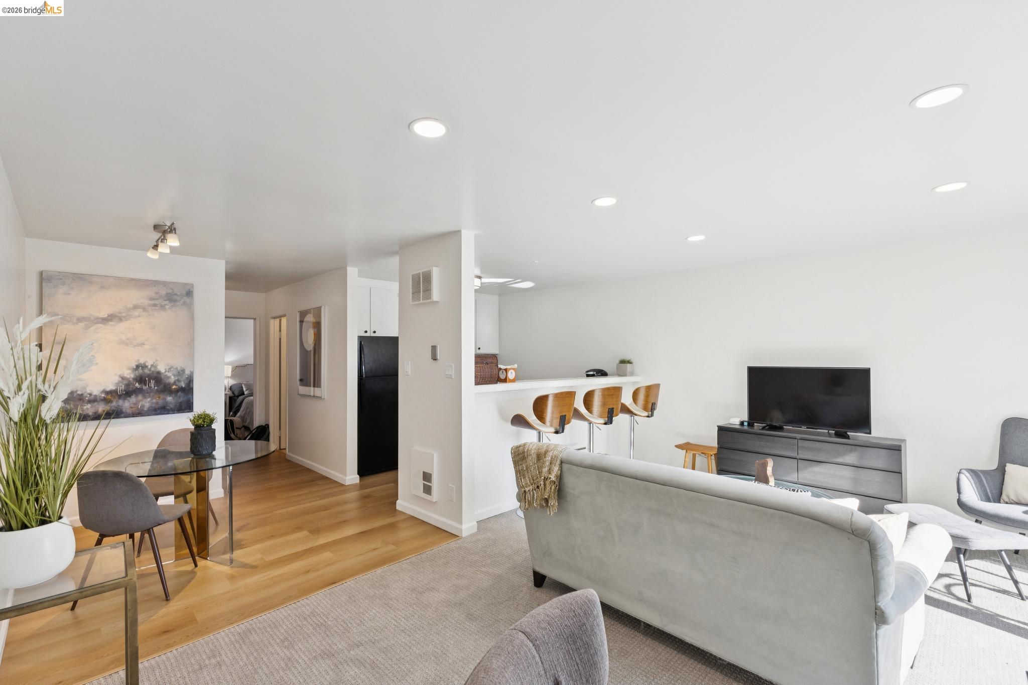 5 Embarcadero, Unit 129 Oakland, CA 94607 - Photo 11 of 32 Living area with recessed lighting, light wood-type flooring, and light colored carpet